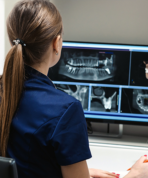 dental-technician-reviewing-xrays-sq_268409826