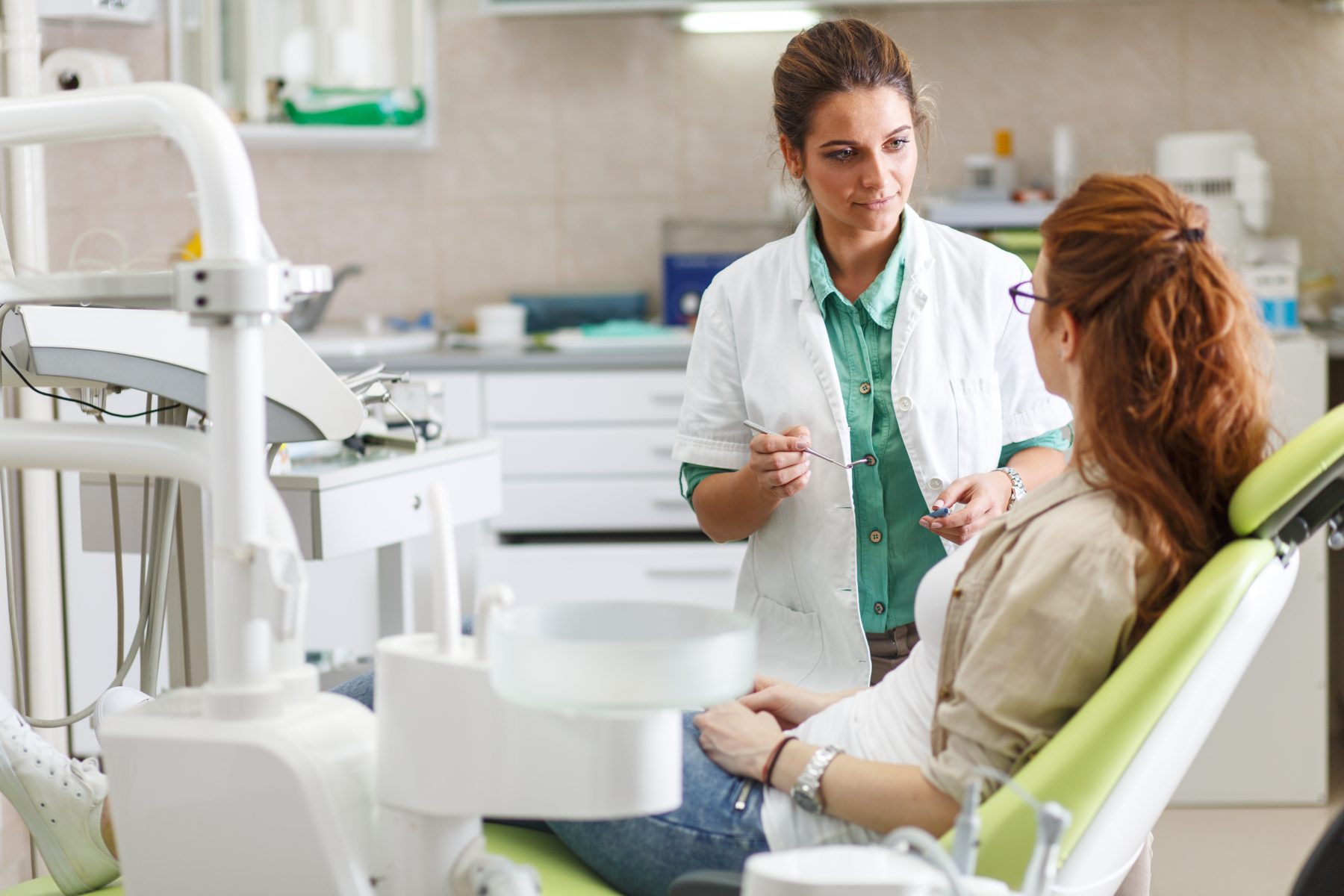 dentist-and-patient-in-chair_126384303