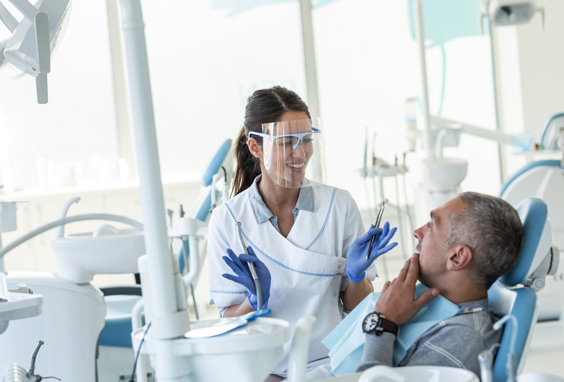 dentist-and-patient-in-chair_332683666