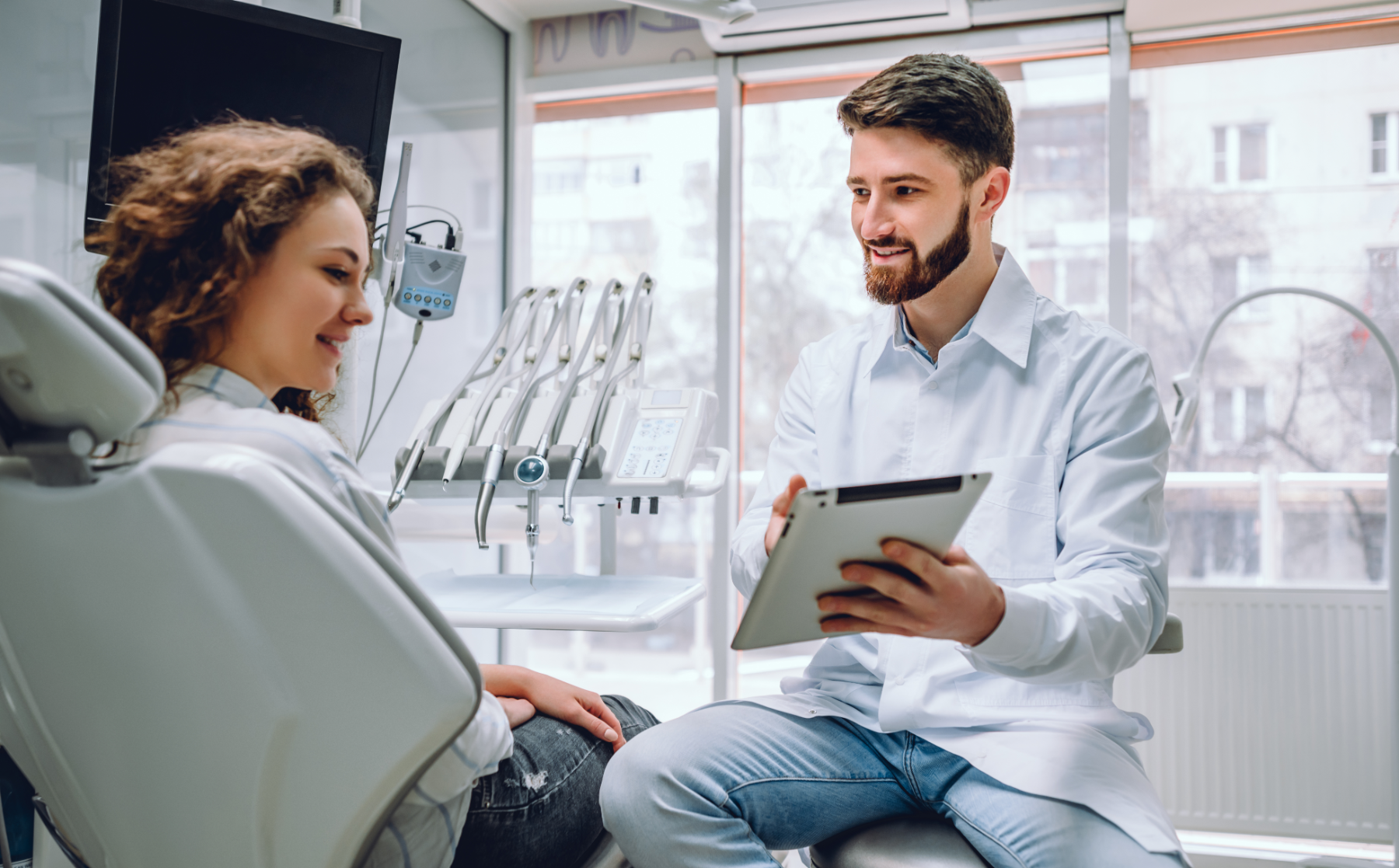 dentist-and-patient-looking-at-tablet_265970598