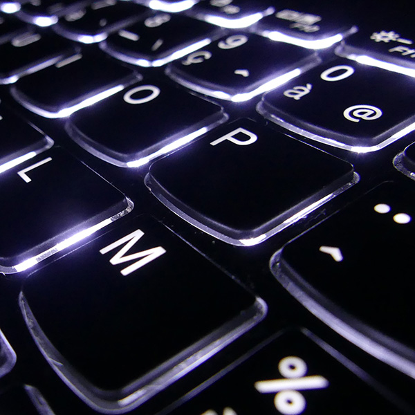 Close up of backlit keyboard to illustrate our access and experience with the most reliable technology.