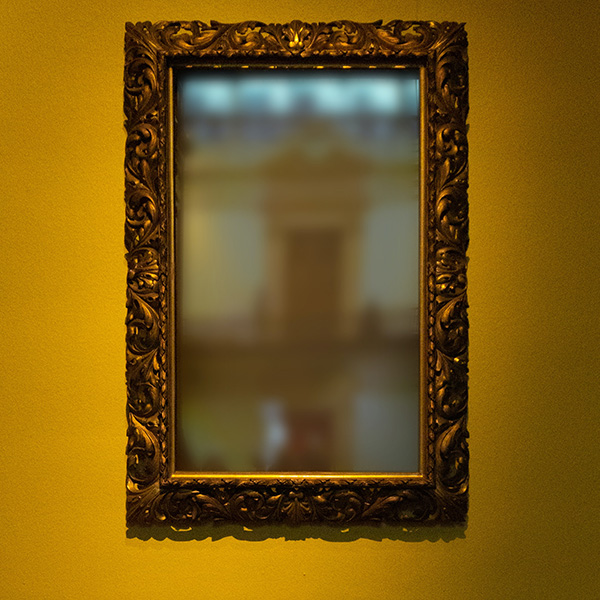A mirror on a wall to represent that data can be mirrored from devices automatically.